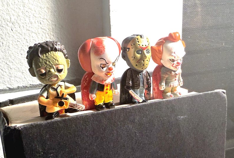 horror characters in a book showing you how they look Pennywise, Jason showing you the horror characters how they look  in the book sticking out so 😎 really cool