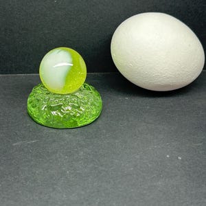 One inch uranium glass marble and green uranium marble stand