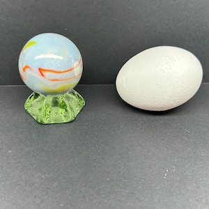Uranium glass marble stand with large white and orange marble