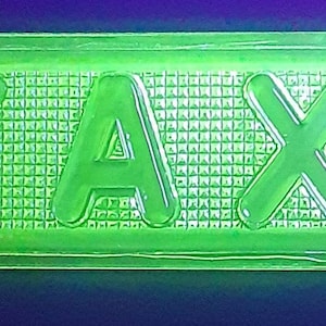 May include: A bright green plastic sign with the word "TAXI" embossed in white.