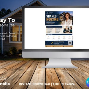May include: A computer monitor displays a flyer for shared housing, featuring a woman's portrait and text. The flyer includes the words "Shared Housing" and "A Place to Belong." The monitor sits on a wooden surface, with the Canva logo in the corner.