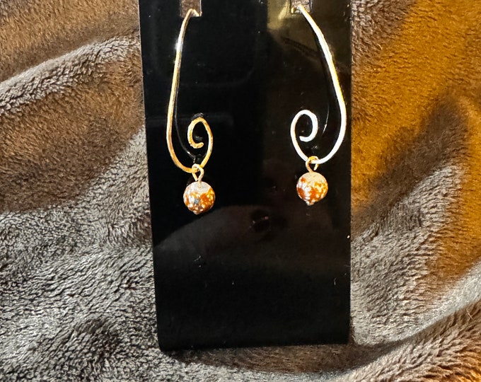 Handmade 1 1/2” V-shaped gold swirl wire earrings with brown glass drop bead and French hook ear wires.