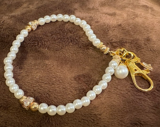 Gifts-Phone wristlet lanyard, 6mm pearls, and crystals with large silver lobster claw closure. Measuring 5” around. Handmade