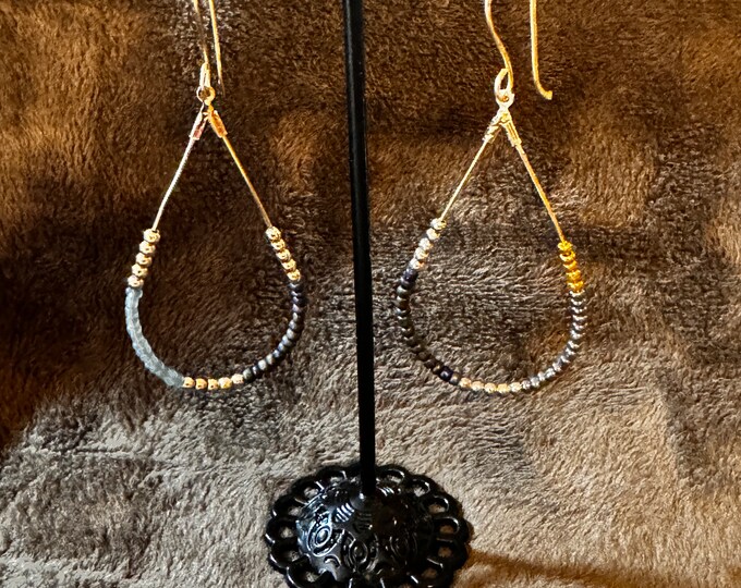 Handmade 3” Gold wired teardrop earrings with gold, blue, gray seed beads surrounding the hoop. Handmade, gold wire fish hook ear wires.
