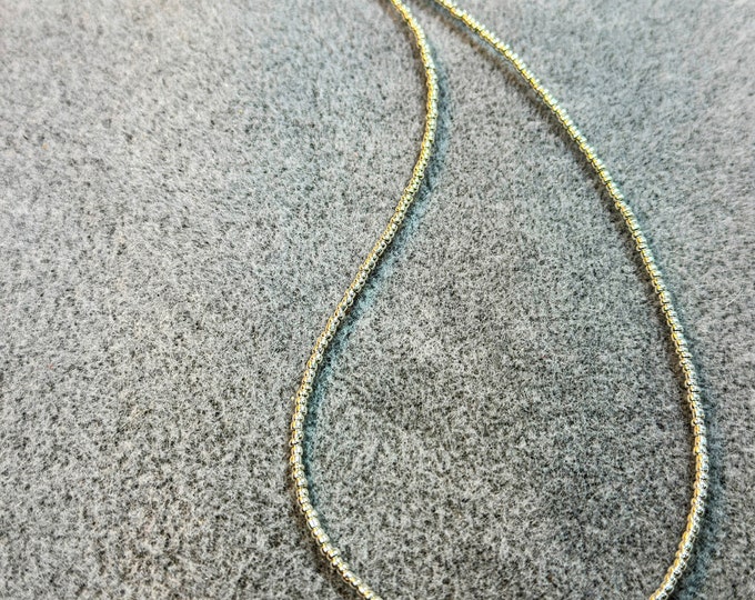 Gifts-22” silver necklace with metallic seed beads and a single 6mm freshwater pearl beaded w/ lobster claw closure and charm.