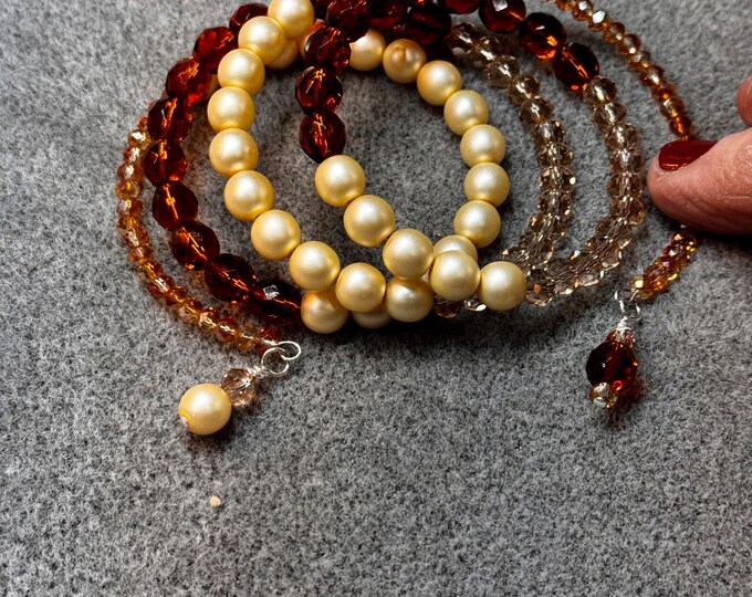 Gifts-Handmade Memory wire bracelet with cream Czech matt 8mm pearls and brown Madeira topaz Czech polish 8mm beads. Two charms on each end.