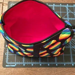 makeup bag-cosmetic bags- toiletries-handmade cosmetic bag with a background in black and rainbow hearts.