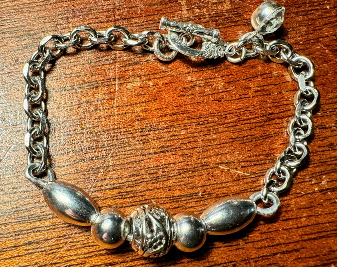Handmade box chain bracelet with silver beads, rhinestone charm, and lobster claw hook closure.  Measures around 7 1/4”