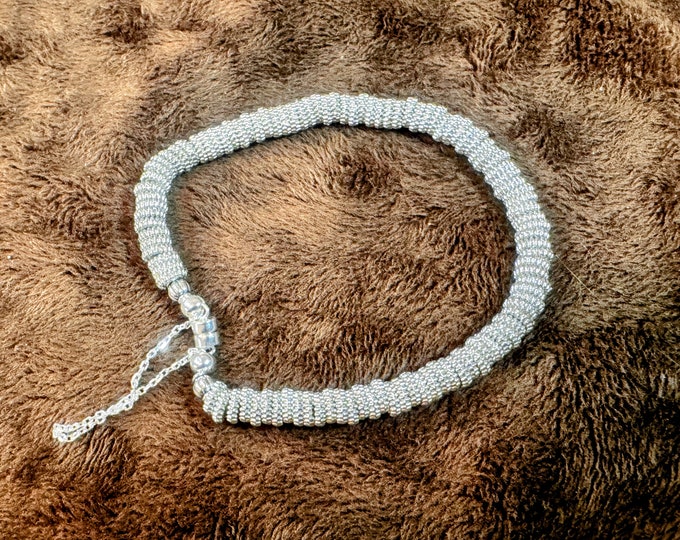 Several small faceted spacer beaded bracelet on regular wire.  Magnet closure with silver guard chain. 7 1/2”  Part of 3 bracelets