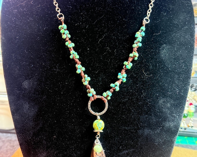 A chain and seed beaded necklace-24” with 3” pendant made of wood-charms on pendant-turquoise seed beads