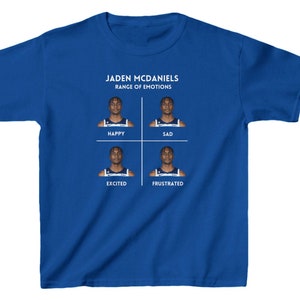 May include: A royal blue youth t-shirt with a graphic of a basketball player's face in four different expressions: happy, sad, excited, and frustrated. The text "Jaden McDaniels Range of Emotions" is printed above the graphic.