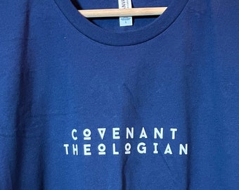May include: A navy blue t-shirt with the text "COVENANT THEOLOGIAN" printed in white on the front.