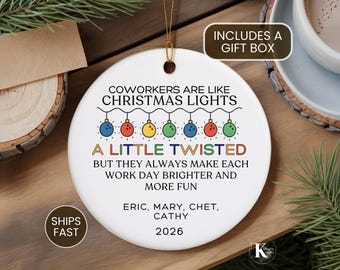 May include: A round white ceramic ornament featuring a string of colorful Christmas light bulbs and the text: COWORKERS ARE LIKE CHRISTMAS LIGHTS A LITTLE TWISTED BUT THEY ALWAYS MAKE EACH WORK DAY BRIGHTER AND MORE FUN. Includes names ERIC, MARY, CHET, CATHY and 2026.