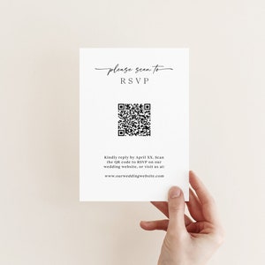 May include: A white card with black text that says "Please scan to RSVP". A black and white QR code is below the text. The text below the QR code says "Kindly reply by April XX. Scan the QR code to RSVP on our wedding website, or visit us at: www.ourweddingwebsite.com"