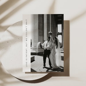 May include: A black and white photo of a bride and groom popping a bottle of champagne in front of a building with columns. The text "LOVE IS PATIENT. BUT WE COULDN'T WAIT." is on the left side of the image.