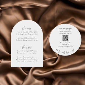 May include: A white wedding invitation with a rounded arch shape. The invitation includes the date, time, and location of the wedding ceremony and reception. It also includes a QR code for guests to RSVP and a request for contributions to the couple's honeymoon fund.