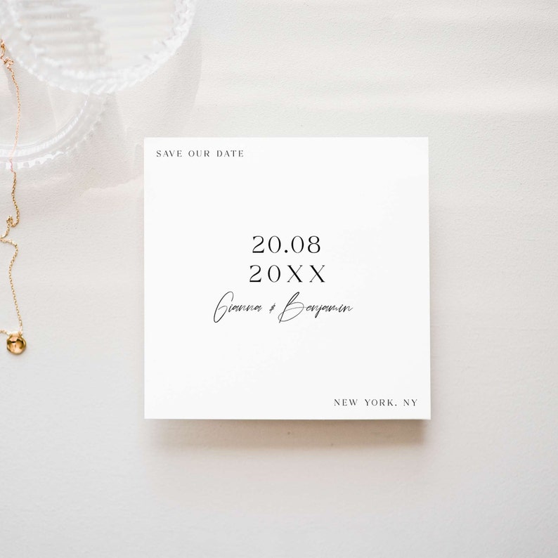 May include: A white save the date card with black text. The text reads 'Save Our Date', '20.08 20XX', 'Gianna & Benjamin', and 'New York, NY'.