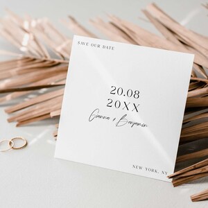 May include: A white save the date card with the text 'Save Our Date' at the top. The date '20.08 20XX' is printed in black below the text. The names 'Gianna & Benjamin' are written in cursive below the date. The text 'NEW YORK, NY' is printed in black at the bottom of the card.