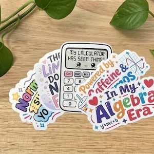 May include: A collection of three die-cut vinyl stickers featuring math-themed designs. One sticker shows a calculator with the text My Calculator Has Seen Things. Another displays the text In My Algebra Era with a heart and the equation y=mx+b.