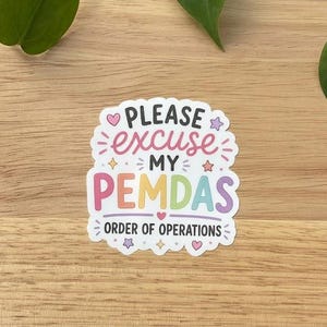 May include: A die-cut sticker featuring the text PLEASE excuse MY PEMDAS ORDER OF OPERATIONS in a mix of black, pink, yellow, green, and purple colors, decorated with small stars and hearts on a white background with a scalloped edge.
