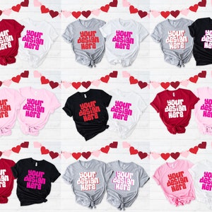 May include: Nine pairs of t-shirts in various colors, including red, pink, black, gray, and white. Each pair has the text "Your design here" printed on the front in a pink font.