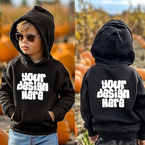 May include: Black hooded sweatshirt with the text "Your design here" in white on the front and back. The sweatshirt is shown on a child wearing blue jeans.