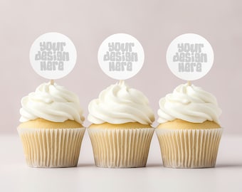 May include: Three white cupcakes with white frosting topped with round white paper circles that say "Your design here" in gray text.