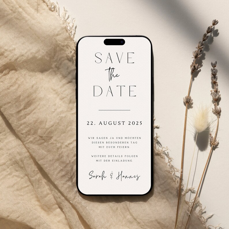 May include: A white save the date card with black text. The card is designed to look like a smartphone screen. The text reads "Save the Date" with a line underneath. The date "22. August 2025" is below the line. The text continues with "Wir sagen ja und m&ouml;chten diesen besonderen Tag mit euch feiern. Weitere Details folgen mit der Einladung. Sarah & Hannes".