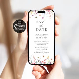 Könnte beinhalten: Eine digitale Save-the-Date-Ankündigung auf einem Smartphone-Bildschirm mit Aquarell-Blumenillustrationen oben und unten, dem Text SAVE THE DATE, LAURA & JANIS, 21.08.2025 sowie einem deutschen Einladungstext.