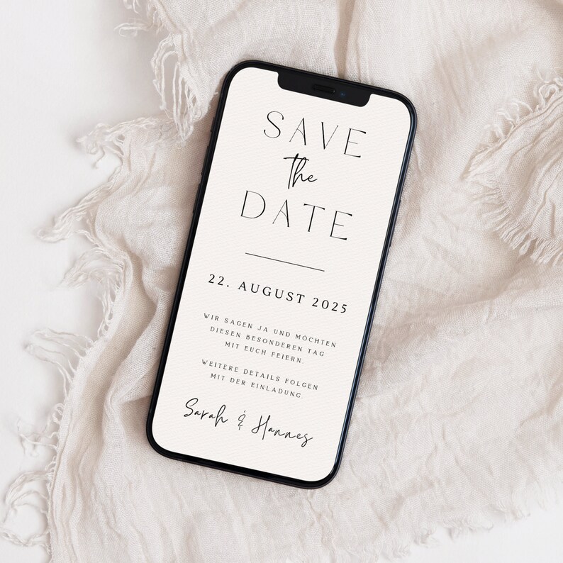 May include: A white smartphone screen with a save the date announcement for August 22, 2025. The text reads "Save the Date" in a minimalist font. The announcement is for Sarah & Hannes.