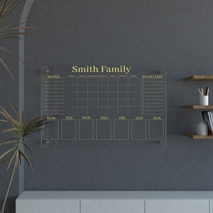 Minimalist acrylic wall planner for family organization at home
