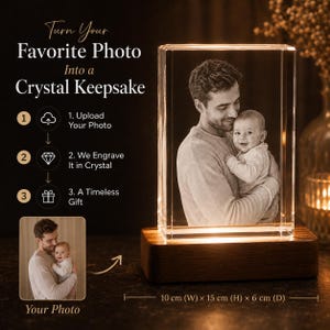 May include: A rectangular crystal block featuring a 3D laser-engraved image of an adult holding a baby, mounted on a rectangular wooden base with internal lighting. Text reads: Turn Your Favorite Photo Into a Crystal Keepsake. Dimensions: 10 cm x 15 cm x 6 cm.
