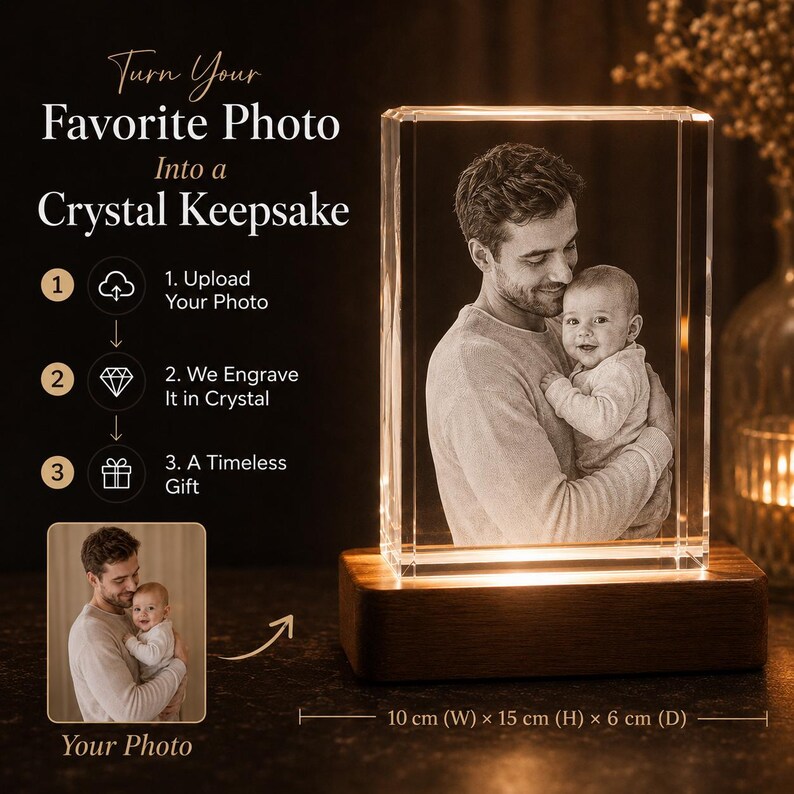 May include: A rectangular crystal block featuring a 3D laser-engraved image of an adult holding a baby, mounted on a rectangular wooden base with internal lighting. Text reads: Turn Your Favorite Photo Into a Crystal Keepsake. Dimensions: 10 cm x 15 cm x 6 cm.