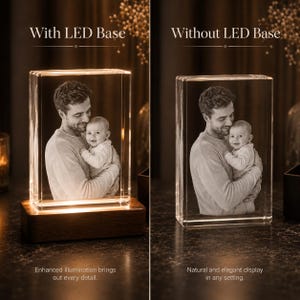 May include: A rectangular glass block featuring a laser-etched monochrome photograph of an adult holding a baby. The left side shows the block on a rectangular wooden LED base with illumination, while the right side shows the block without the base.