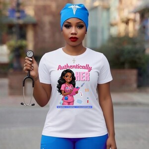 May include: White t-shirt with the text "Authentically HER" and a cartoon nurse illustration. The shirt also has the words "Strong, Caring, Unstoppable" below the illustration. The person in the image is wearing a blue medical cap and holding a stethoscope.