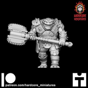 May include: A grey 3D-printed miniature of a frog-like warrior figure, wielding a large double-bladed saw weapon. The figure is wearing armour with spiked shoulder pads and a skull emblem. The Hardcore Miniatures logo is in the top right corner.