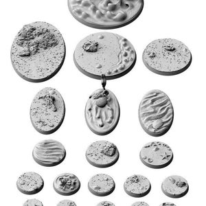 May include: A set of 17 round and oval miniature terrain bases for tabletop gaming. The bases feature various textures and designs, including sand, rocks, and water.