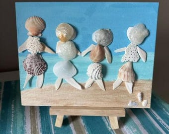 Arte en lienzo de conchas marinas de damas en la playa