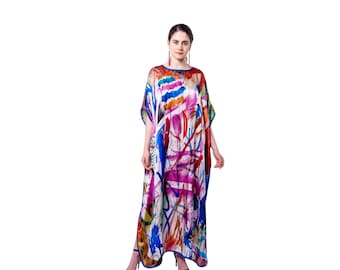May include: A long, flowing, colorful kaftan with a white background and abstract patterns in shades of pink, blue, orange, and yellow. The kaftan has a loose, comfortable fit and is perfect for warm weather.