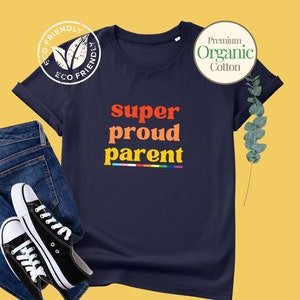 May include: Navy blue t-shirt with the text "super proud parent" in rainbow colours. The shirt is made of organic cotton and has a relaxed fit.