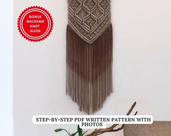May include: A macrame wall hanging with a geometric design in shades of brown and beige. The wall decor features a wooden bar at the top and long fringe at the bottom. The text "STEP-BY-STEP PDF WRITTEN PATTERN WITH PHOTOS" is visible.