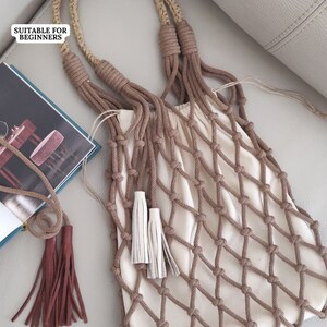 May include: A beige crocheted net bag with brown rope handles and tassels. The bag is suitable for beginners to crochet.