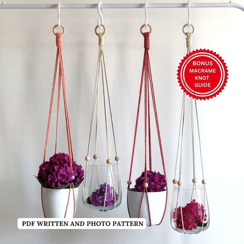 May include: Three macrame plant hangers with wooden beads, each holding a different type of pot with pink flowers. The hangers are made with pink, white, and beige cord. A red circle with the text "Bonus Macrame Knot Guide" is in the upper right corner.