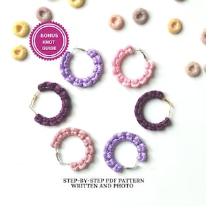May include: Five pairs of crocheted hoop earrings in pink, purple, and white. The earrings are arranged in a circle on a white background. The text "Bonus Knot Guide" is visible in the top left corner of the image. "Step-by-step PDF Pattern Written and Photo" is visible at the bottom of the image.