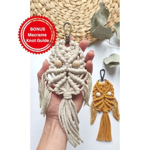 May include: Two macrame keychains with wooden beads. One is cream coloured and the other is mustard yellow. Both have a tassel at the bottom.