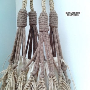 May include: Close-up of the knotted ends of four beige macrame cords, with a white fabric bag in the centre. The text "SUITABLE FOR BEGINNERS" is visible in the top right corner of the image.