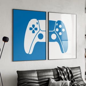 May include: Two framed prints of white video game controllers on a blue and white background. The controllers are in a simple silhouette style.