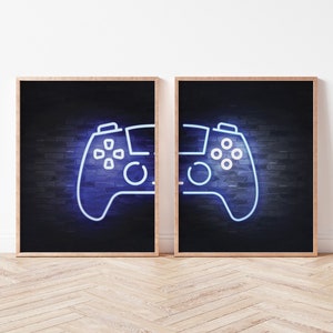 May include: Two framed prints of a neon blue video game controller on a brick wall background.