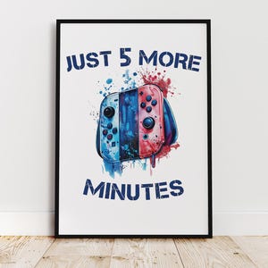 May include: Framed print featuring a watercolor-style illustration of a game controller in blue and red hues. The text "JUST 5 MORE MINUTES" is printed above and below the controller in a distressed blue font.