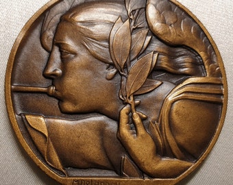 Médaille art déco française 50 mm en bronze femme soufflant de la trompette par Delannoy Journal